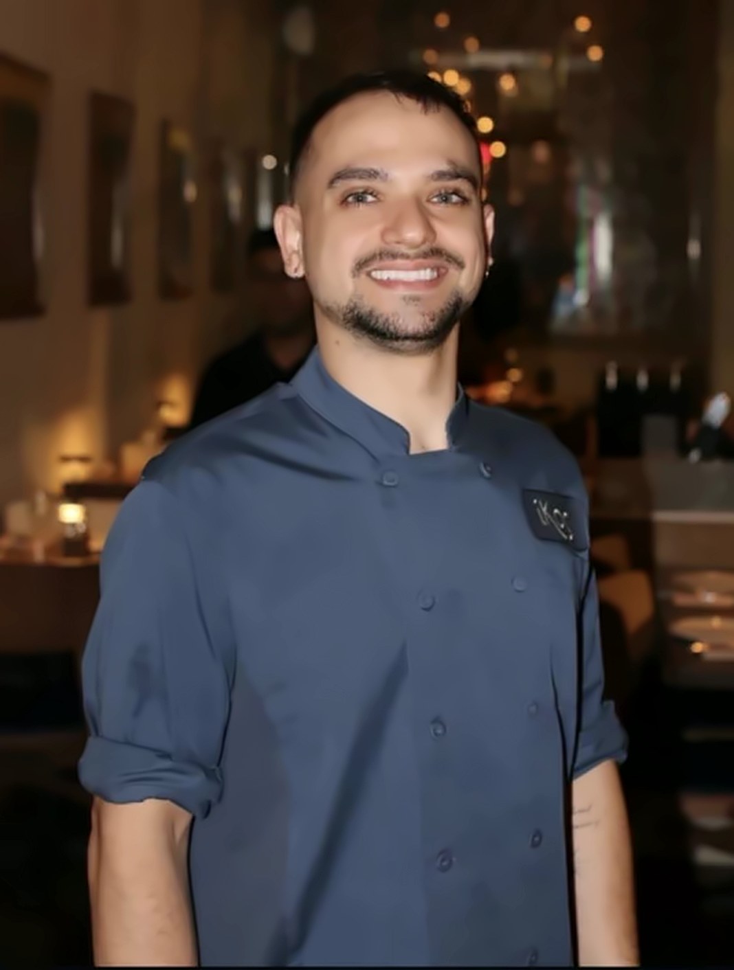 Executive Chef Davide Zucca smiling in the IKOS dining room